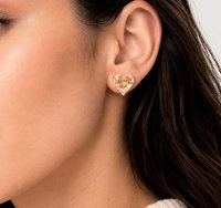 Model wearing a 13mm gold plated heart crystal stud earring made with Swarovski Crystals in a warm champagne shade, elegant everyday jewelry.