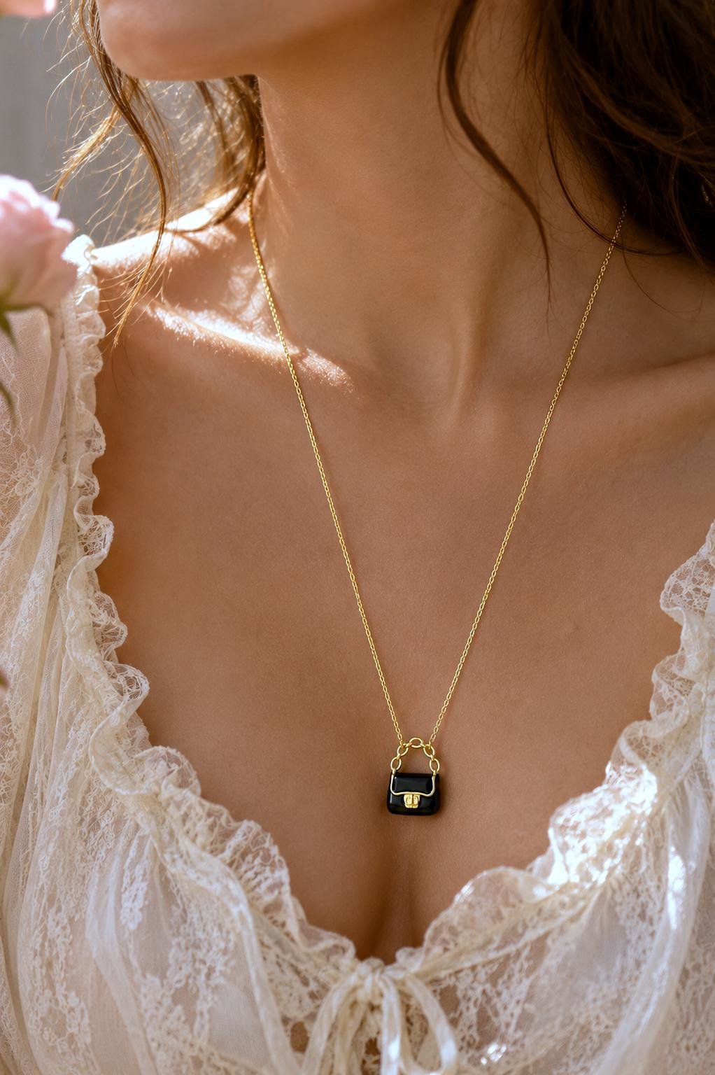 Stylish black handbag pendant necklace for everyday wear.