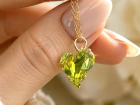 Citrus green crystal Sweet Heart pendant necklace on a delicate gold cable chain.