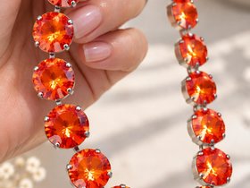 large 12mm swarovski Orange Ignite Rivoli crystals showing their vivid fiery orange sparkle.